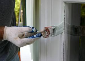 Putting on a second coating of paint on a Braselton home