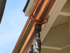 drilling holes at each downspout location